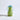Green vase with blue handles on a white background